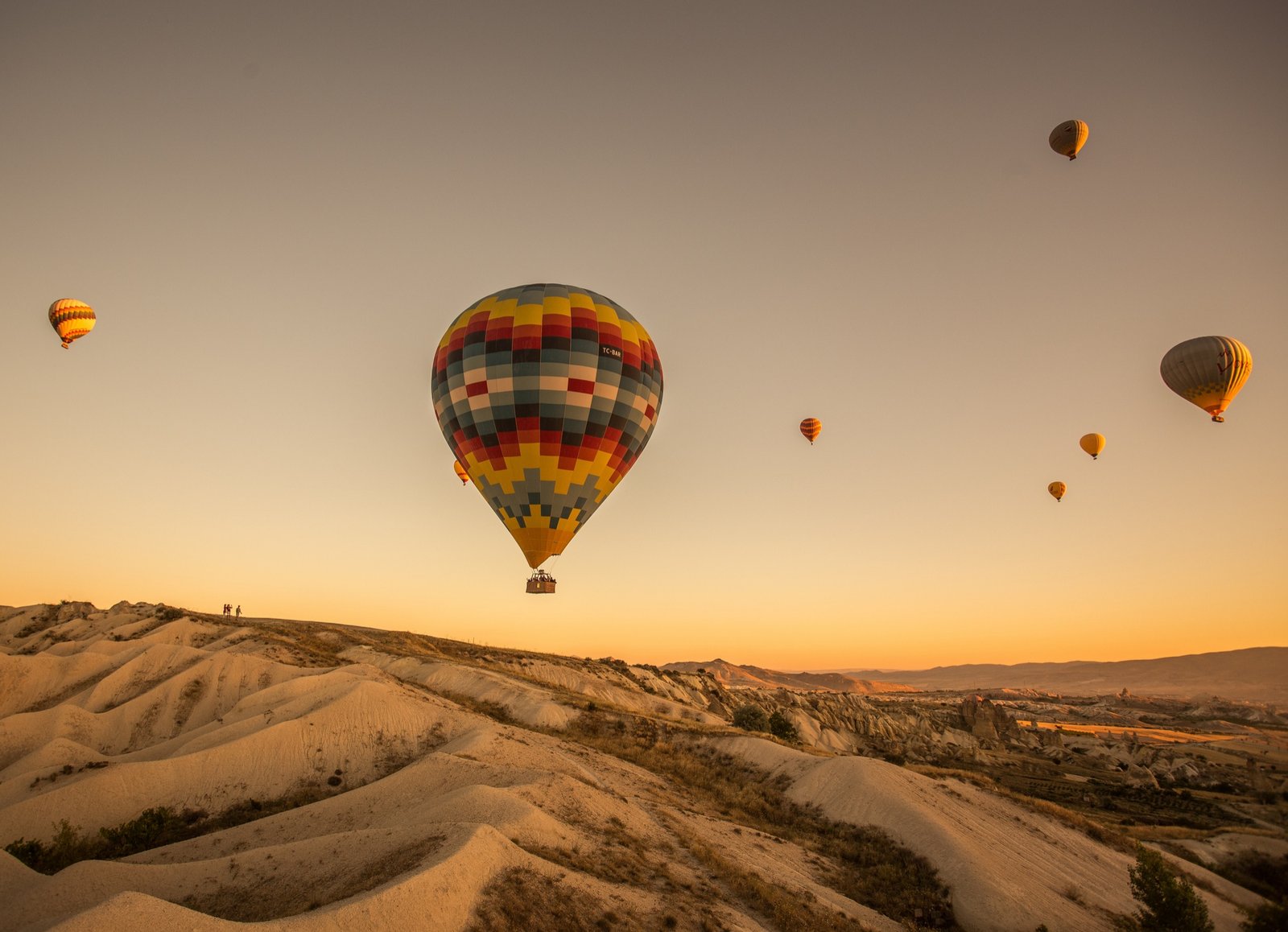 hot-air-balloons-hills-fields-during-sunset-cappadocia-turkey